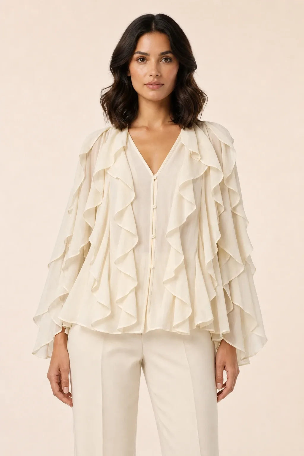 Yellow cascading ruffle blouse on a model in a contrapposto stance