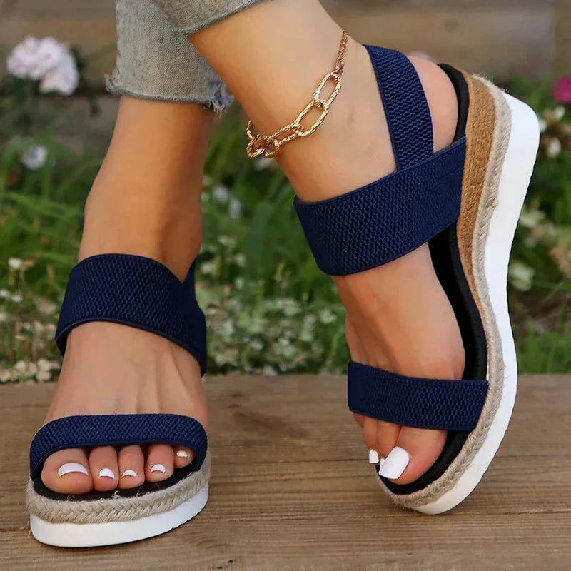 Blue wedge espadrille sandal, heel view displaying woven jute wedge and back strap