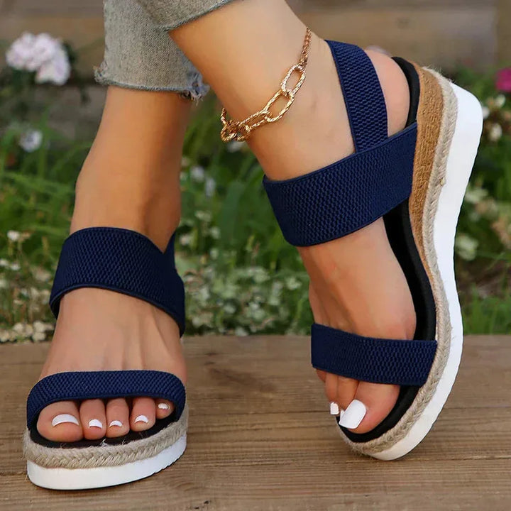 Blue wedge espadrille sandal, heel view displaying woven jute wedge and back strap