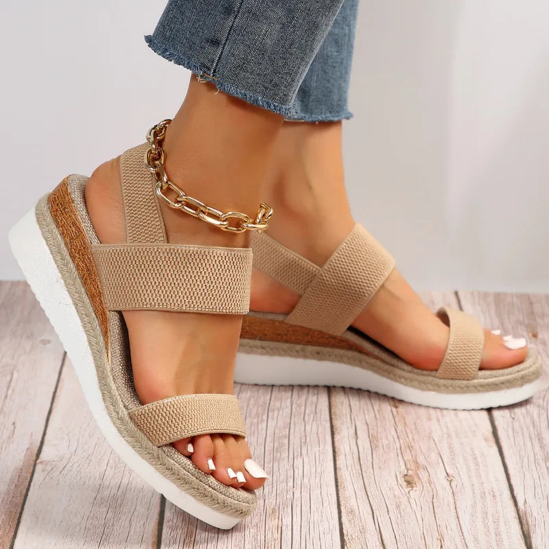 Brown wedge espadrille sandal, front view showing toe straps and woven platform sole