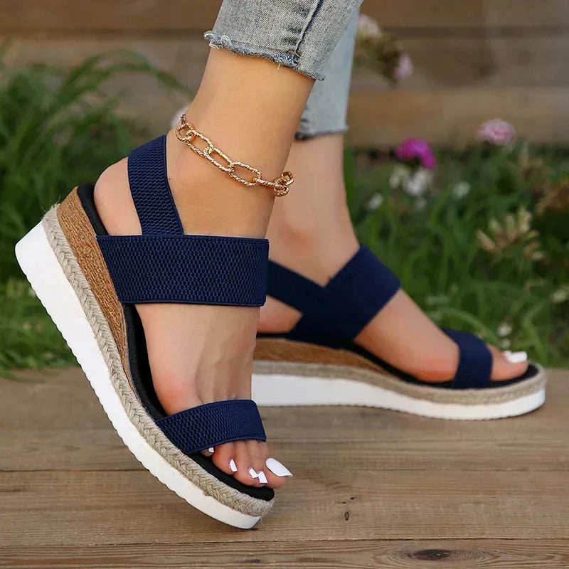 Brown wedge espadrille sandal, close-up of toe strap and woven platform detailing