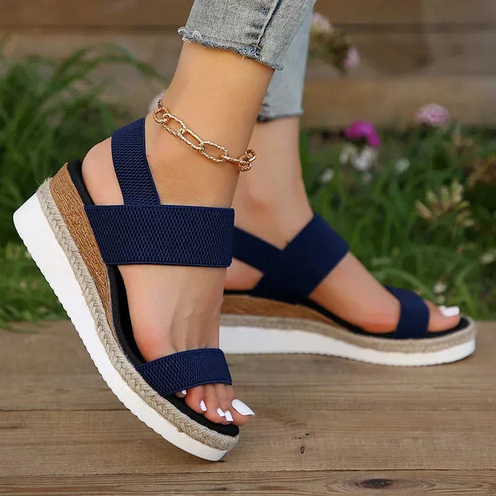 Brown wedge espadrille sandal, close-up of toe strap and woven platform detailing