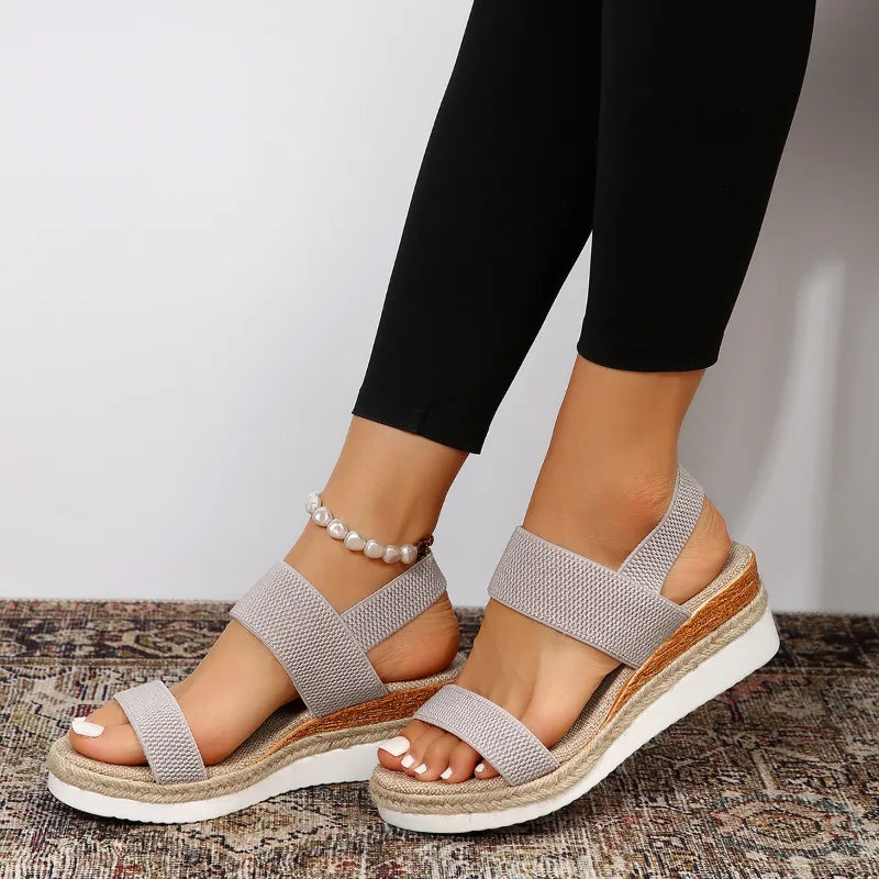 Gray wedge espadrille sandal, close-up detail of woven texture and sandal hardware
