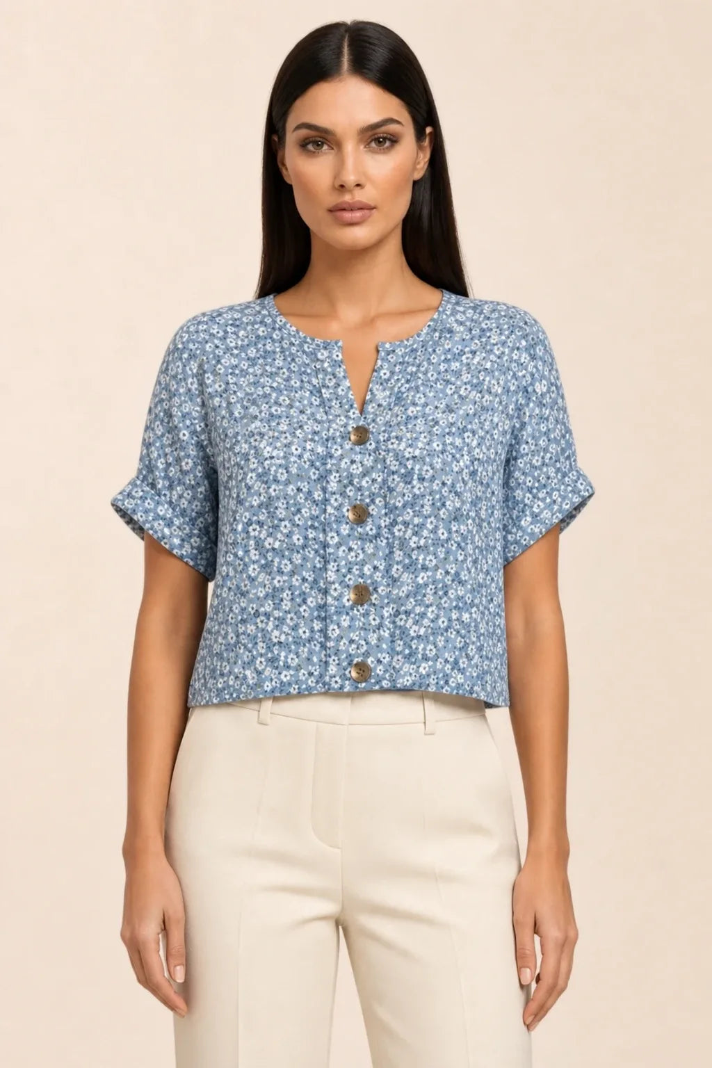 Blue ditsy floral button blouse on model in contrapposto stance