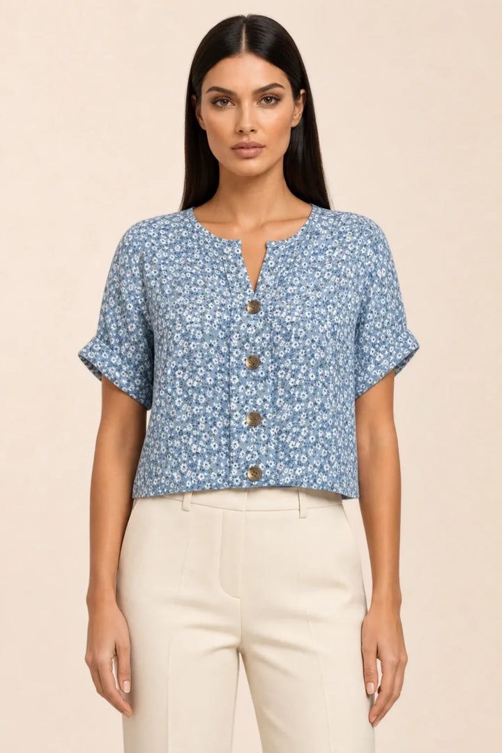 Blue ditsy floral button blouse on model in contrapposto stance