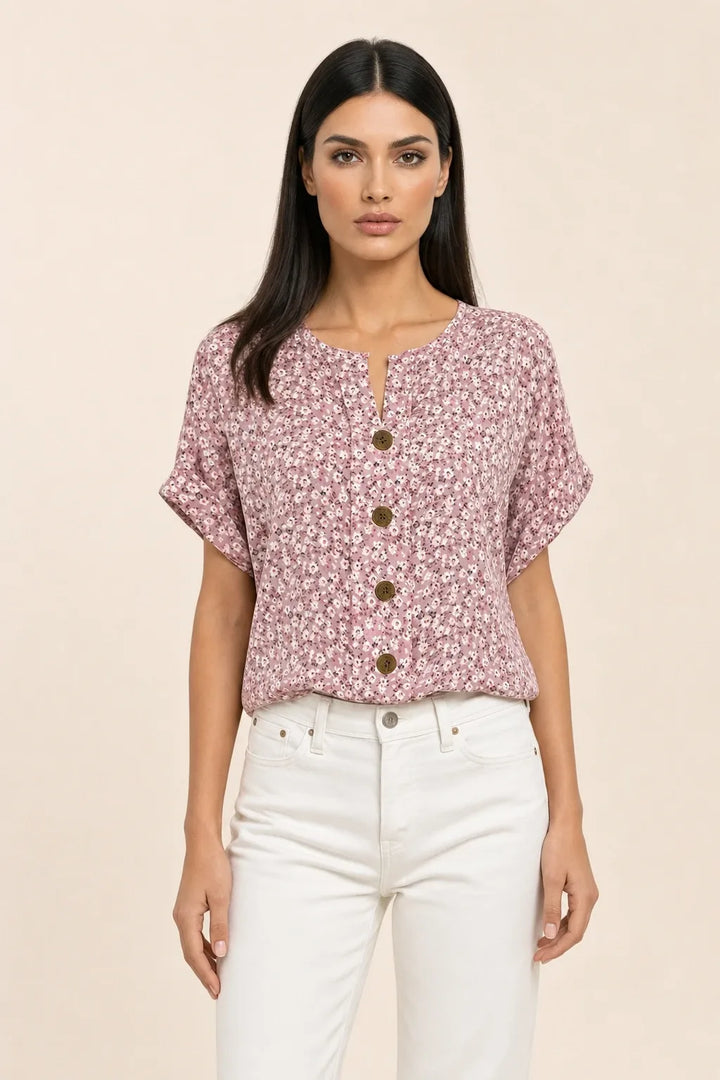 Pink ditsy floral button blouse on model in contrapposto stance