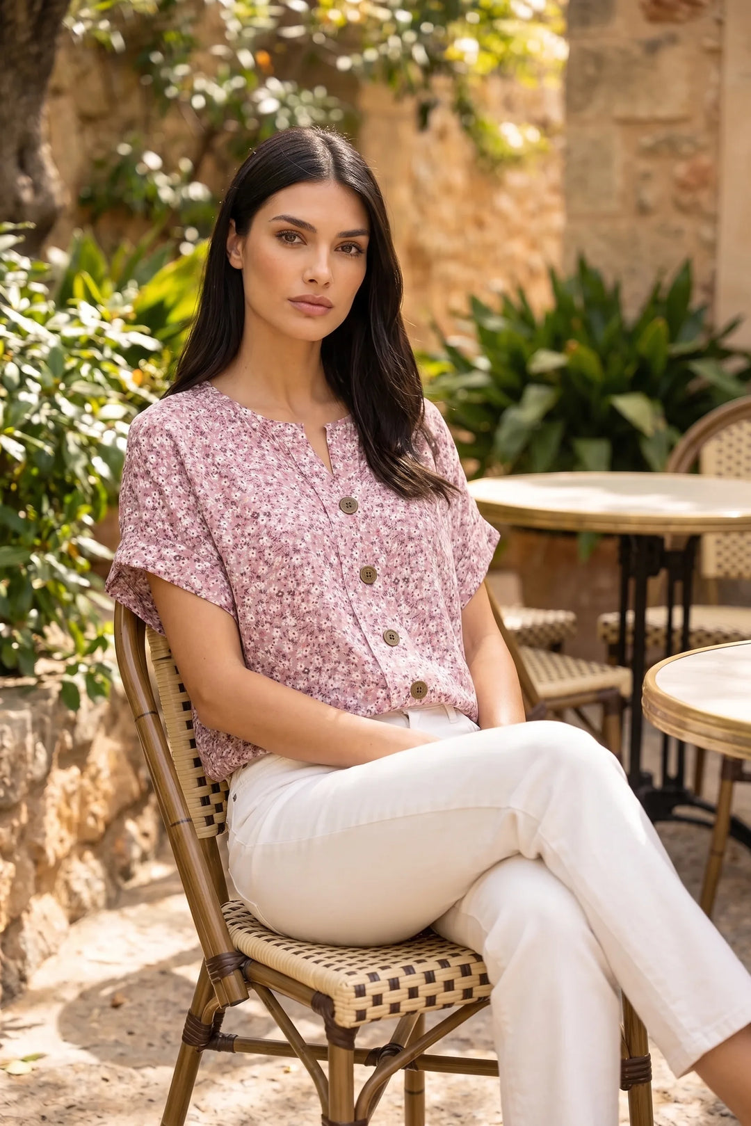 Model wearing pink ditsy floral button blouse in casual lifestyle setting