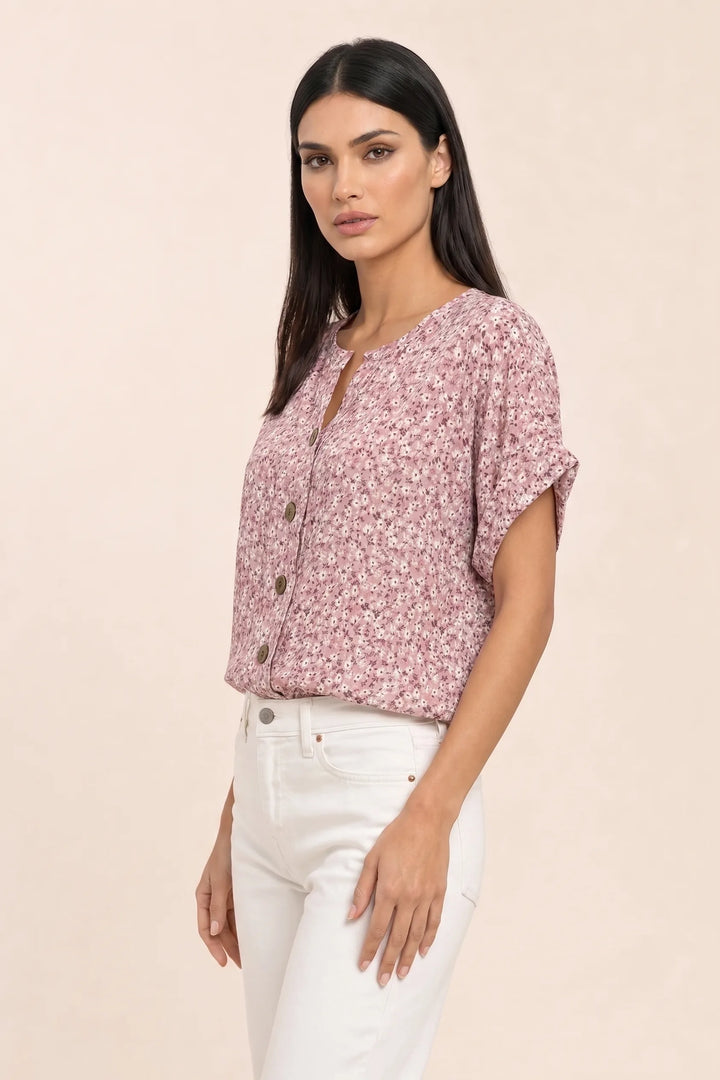 Pink ditsy floral button blouse on model in three-quarter turn