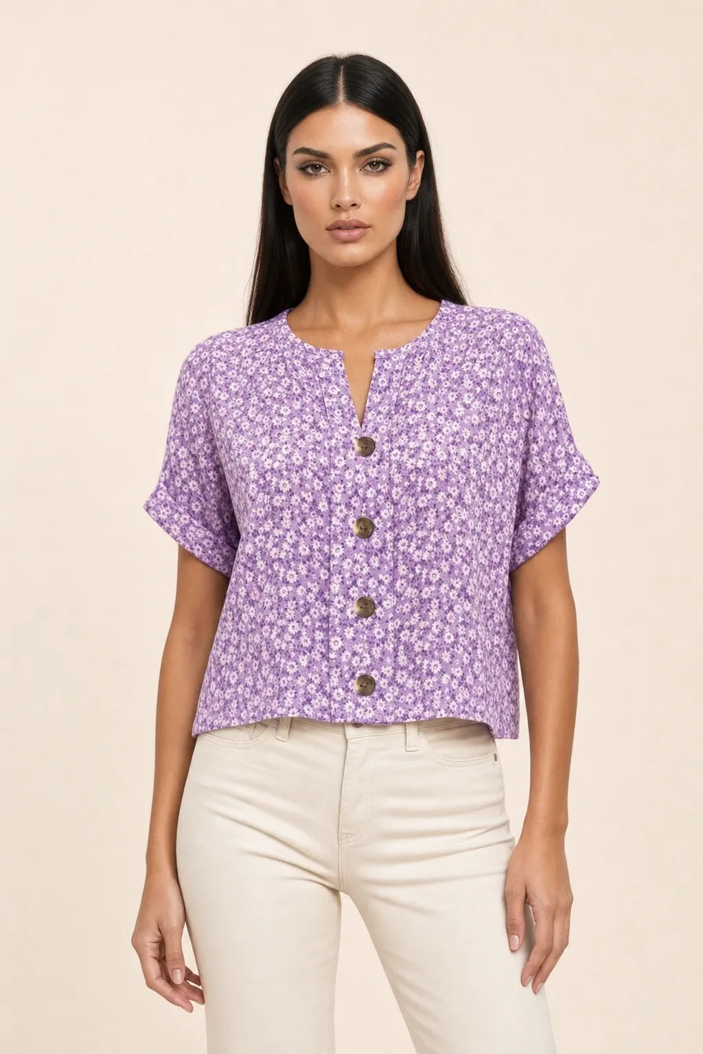 Purple ditsy floral button blouse on model in contrapposto stance