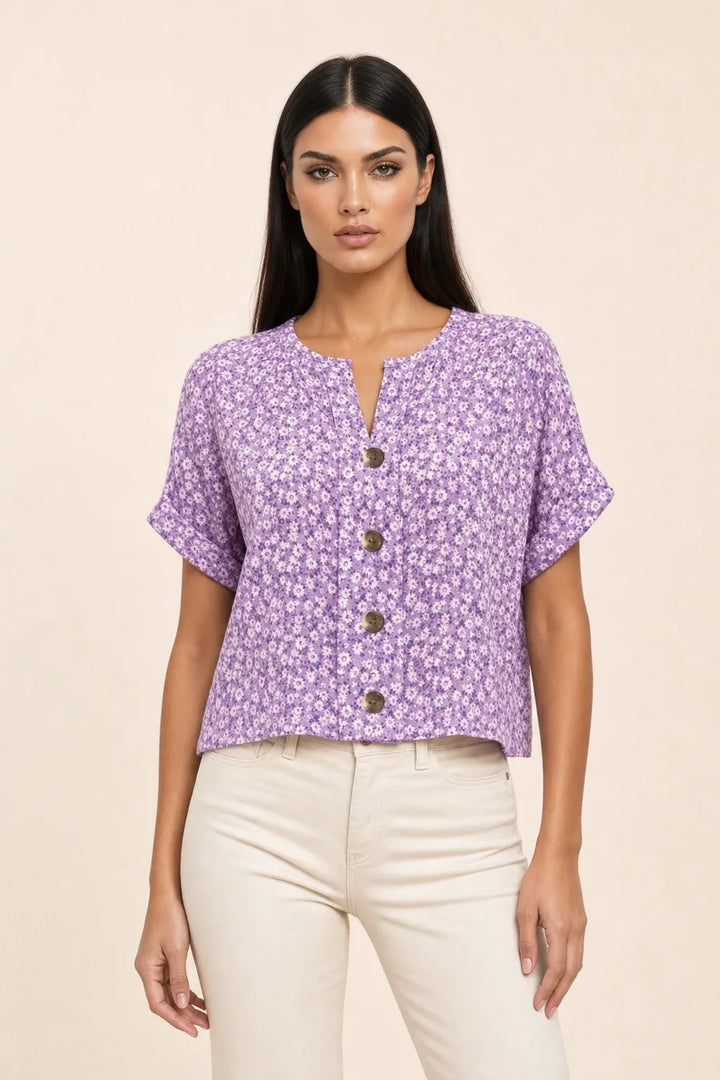 Purple ditsy floral button blouse on model in contrapposto stance