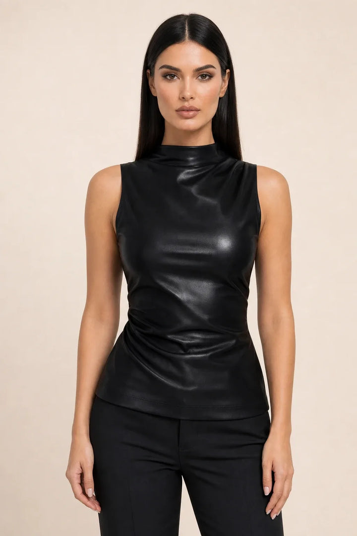 Black faux leather mock neck top on model in contrapposto stance