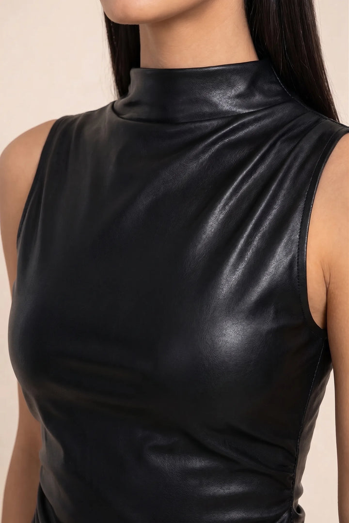 Close-up detail of black faux leather mock neck top