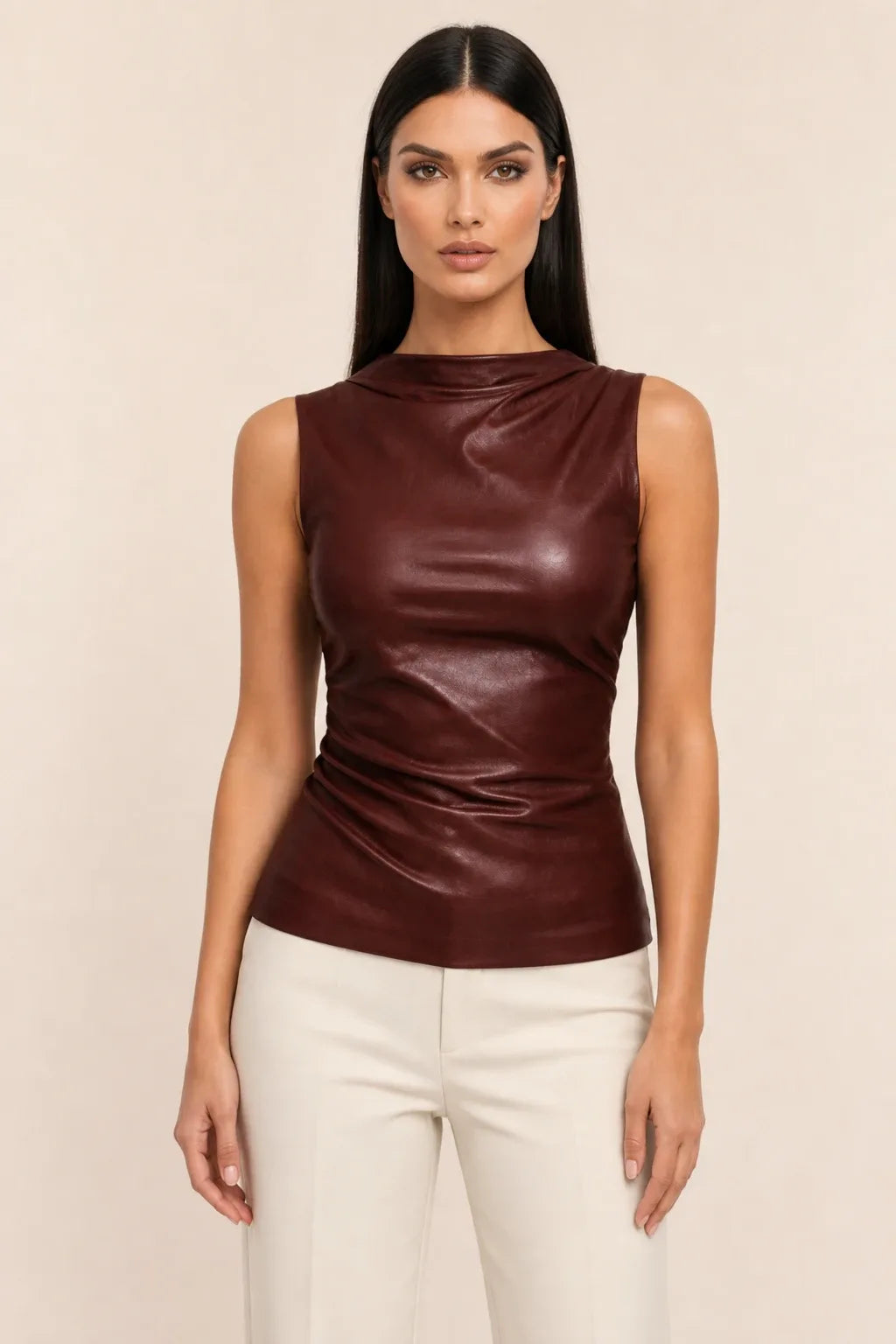 Brown faux leather mock neck top on model in contrapposto stance