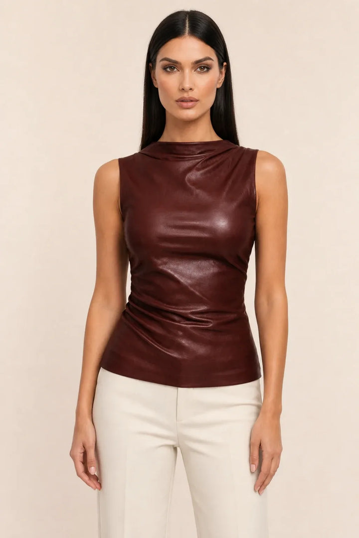 Brown faux leather mock neck top on model in contrapposto stance