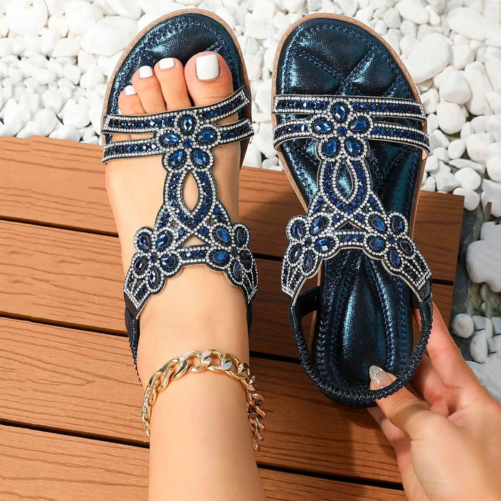 Blue rhinestone flat sandal with boho straps, heel view