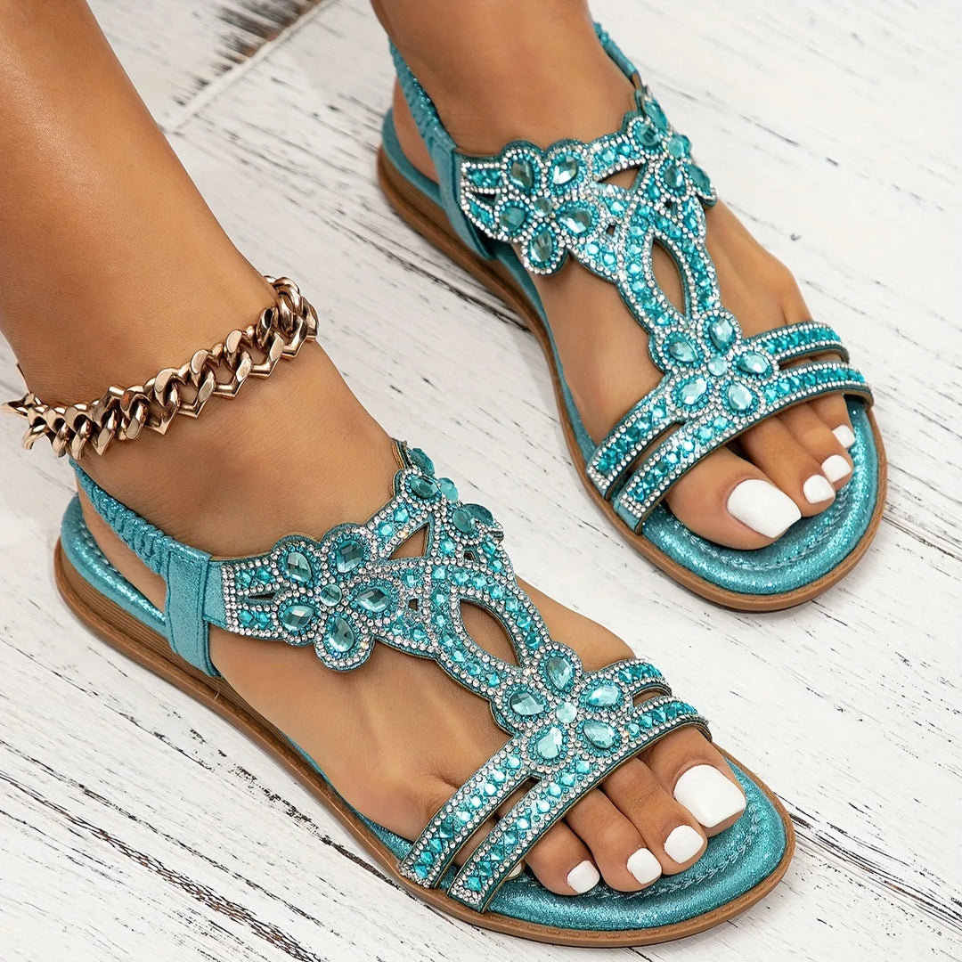 Sky blue rhinestone flat sandal with boho straps, three-quarter view