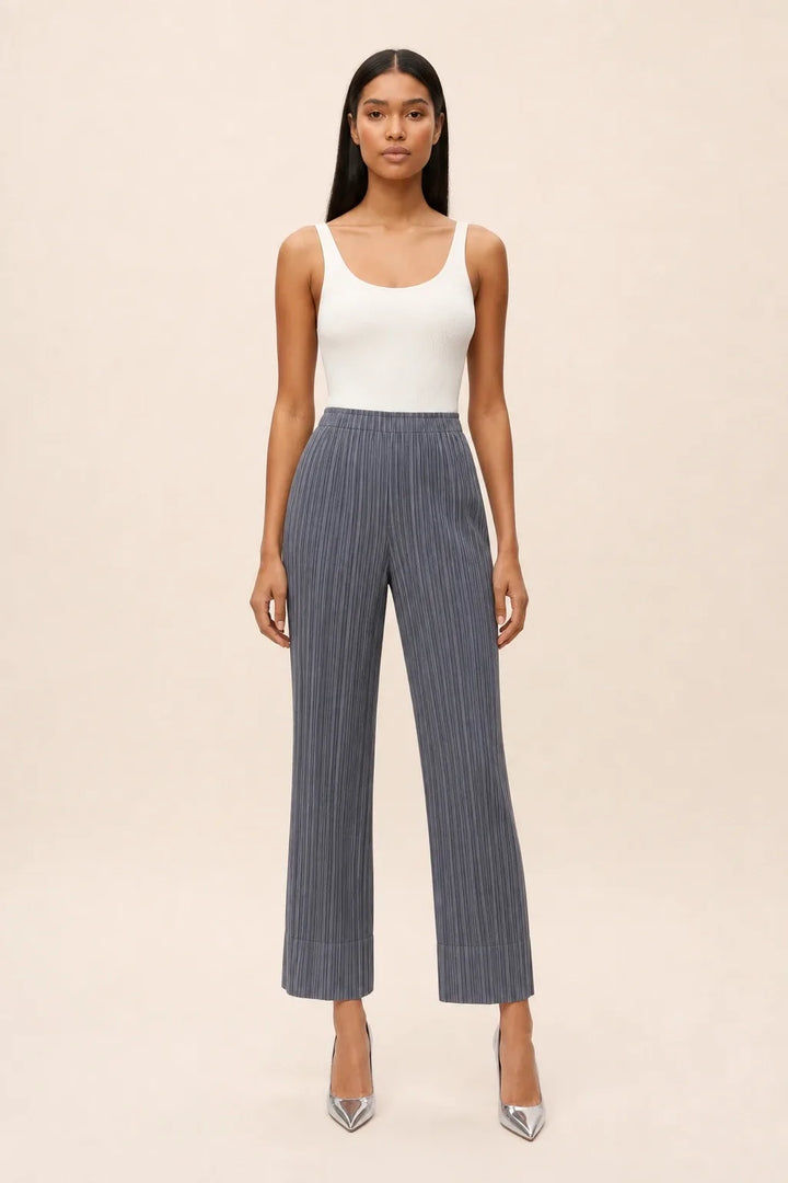 Gray pleated cropped pants on a model in a contrapposto stance