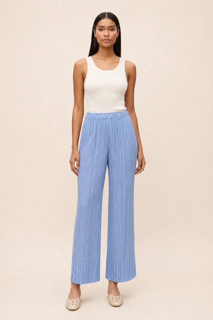 Sky blue pleated cropped pants on a model in a contrapposto stance