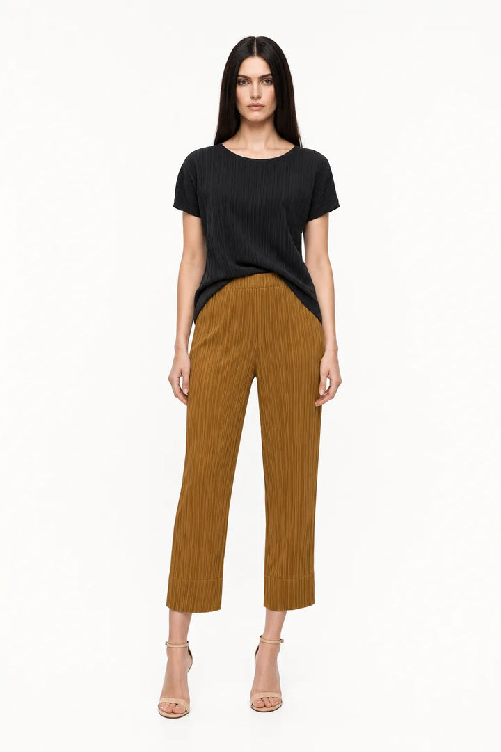 Caramel pleated cropped trousers on a model in a contrapposto stance