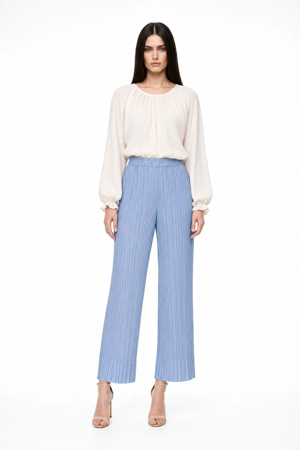 Sky blue pleated cropped trousers on a model in a contrapposto stance