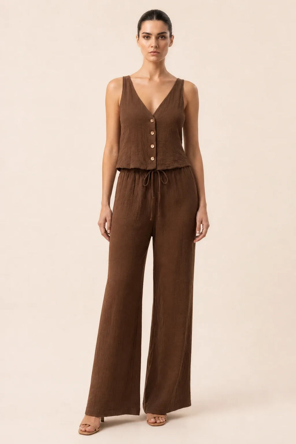 Brown button-front vest and wide-leg trousers set on model in contrapposto stance
