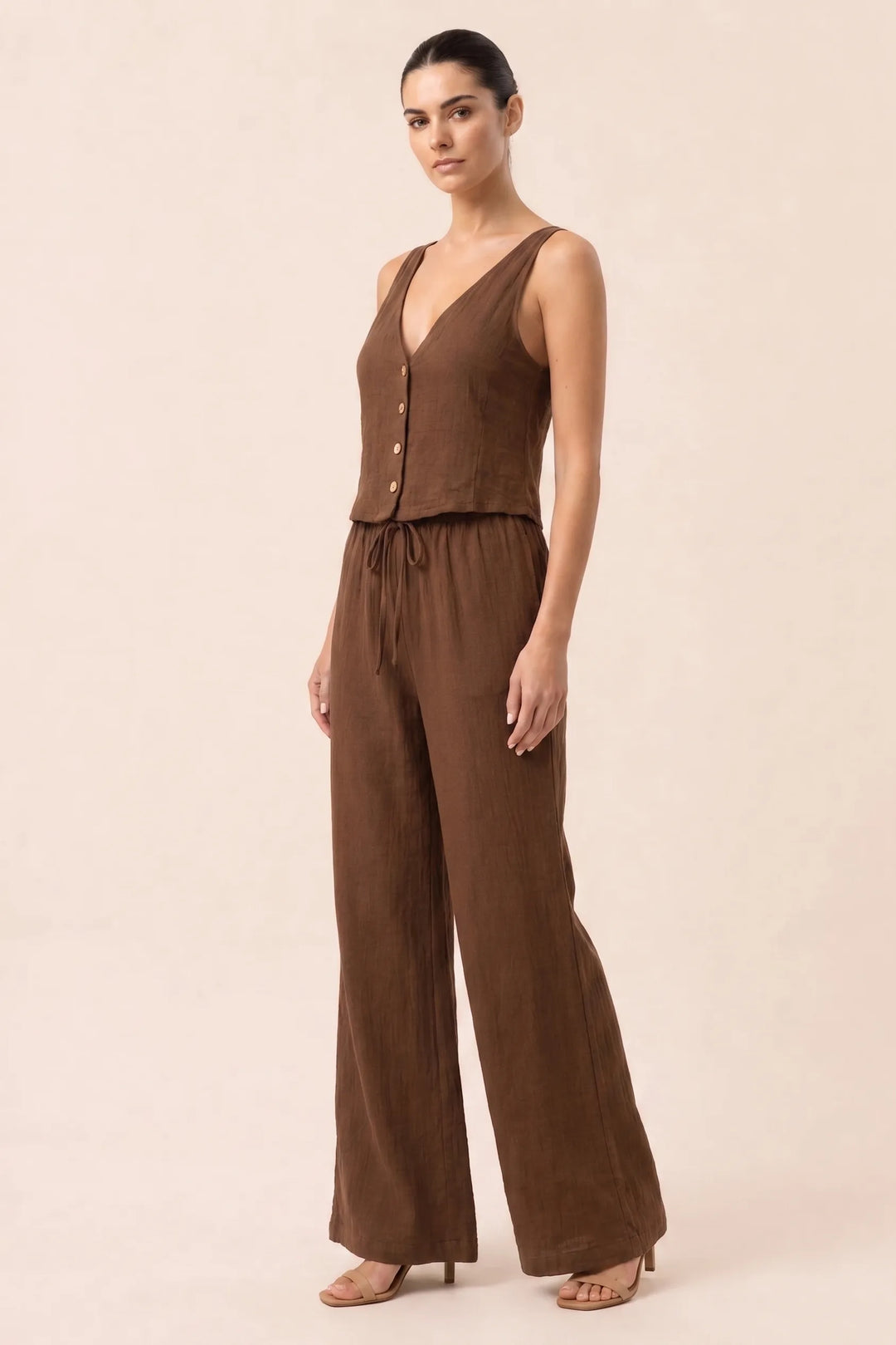 Brown button-front vest and wide-leg trousers set on model in three-quarter turn