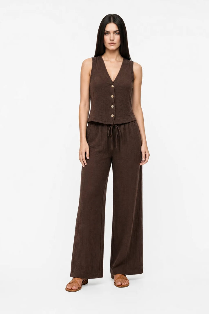 Coffee brown button-front vest and matching trousers on a model in a contrapposto stance