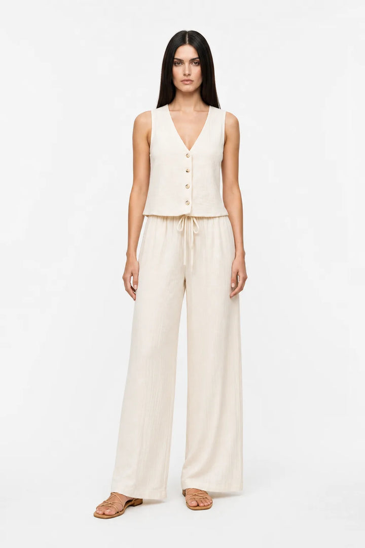 White button-front vest and matching trousers on a model in a contrapposto stance