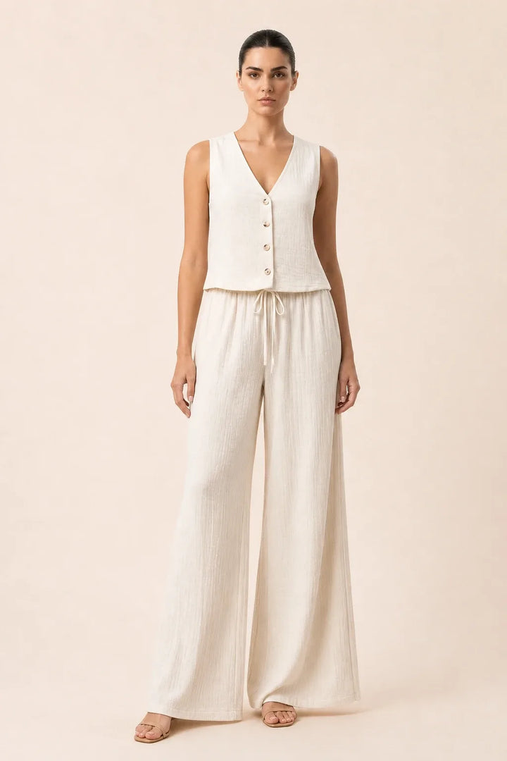 White button-front vest and wide-leg trousers set on model in contrapposto stance