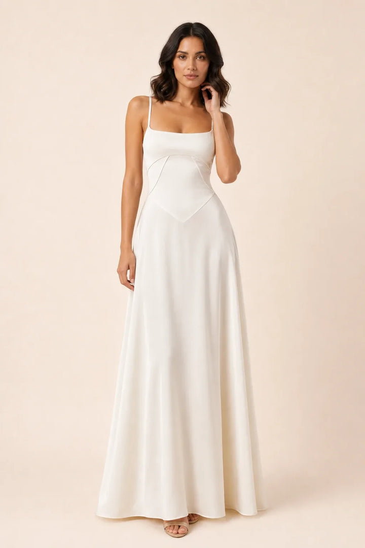 Ivory corset-seam maxi dress on a model in a contrapposto stance