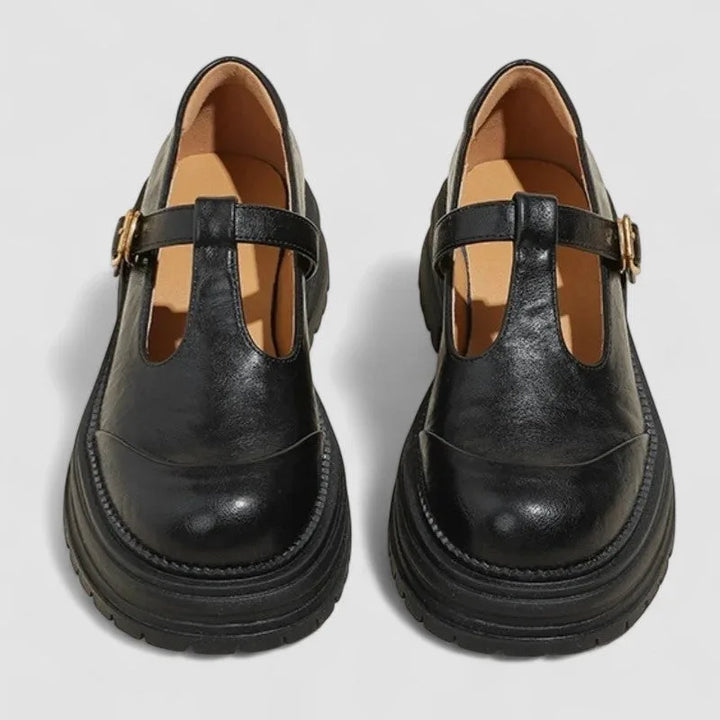 Black platform T-bar Mary Jane shoe, side profile highlighting heel height and strap