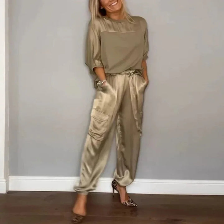 Model facing forward in a gold satin cargo jacket and matching wide-leg pants