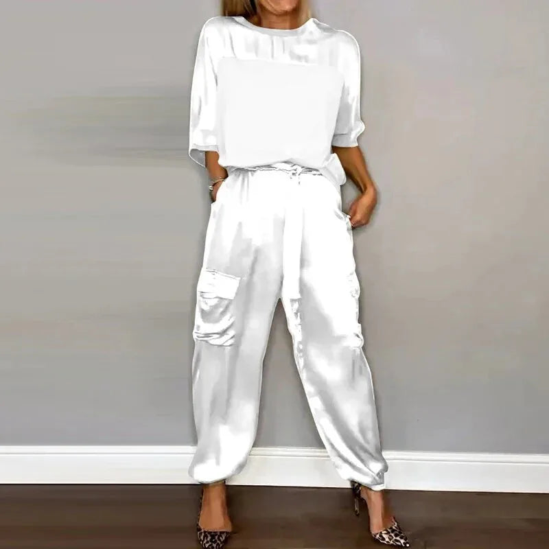 Model in a white satin cargo jacket and wide-leg pants, full-length view