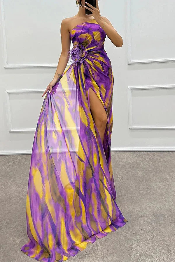 Model posing in a blue feather-trim maxi dress