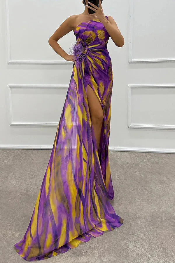 Close-up detail of feather trim on a purple maxi dress hemline