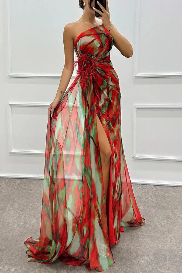 Model in a three-quarter turn wearing a red feather-trim maxi dress
