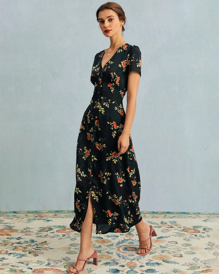 Model facing forward in a black floral maxi dress with a flowing silhouette
