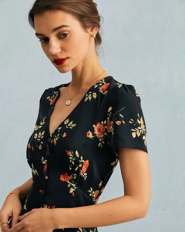 Model in three-quarter turn wearing a black floral maxi dress