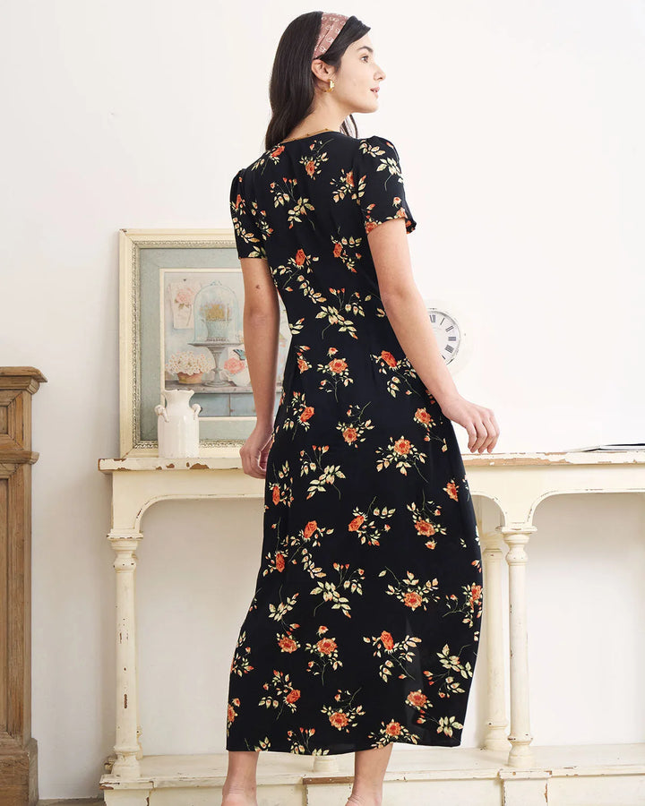 Model in a black floral maxi dress showing the skirt movement
