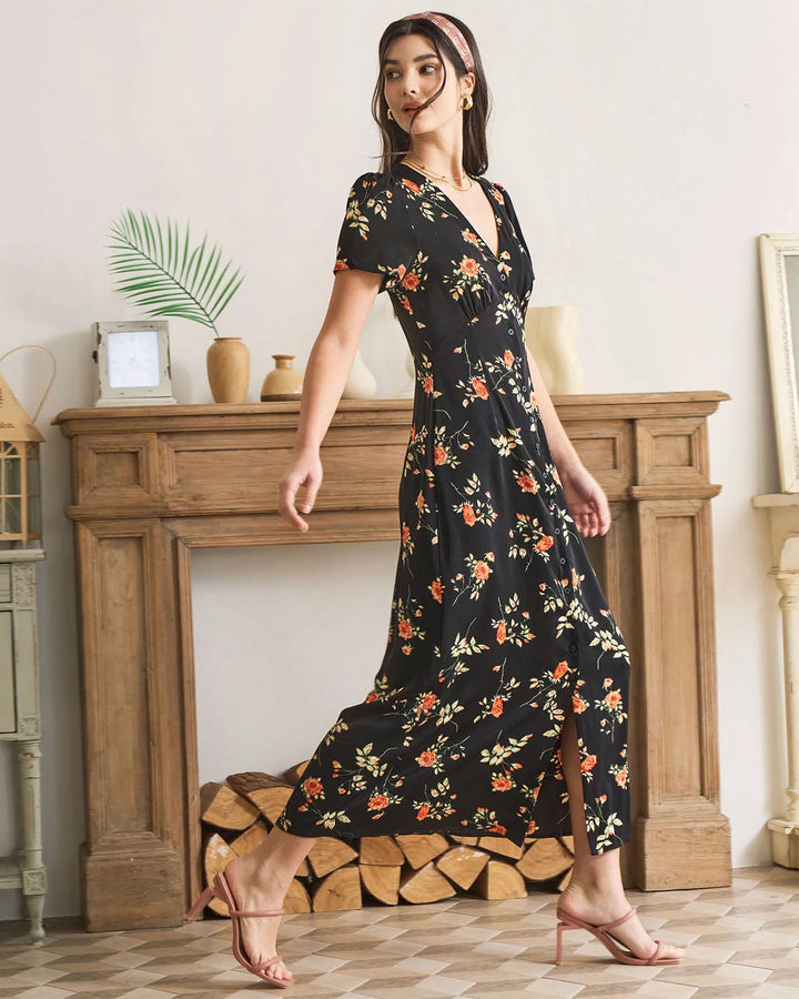 Model wearing a black floral maxi dress with a styled pose