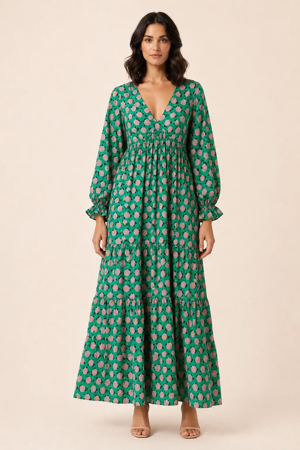 Woman in green floral tiered maxi dress, standing in contrapposto pose