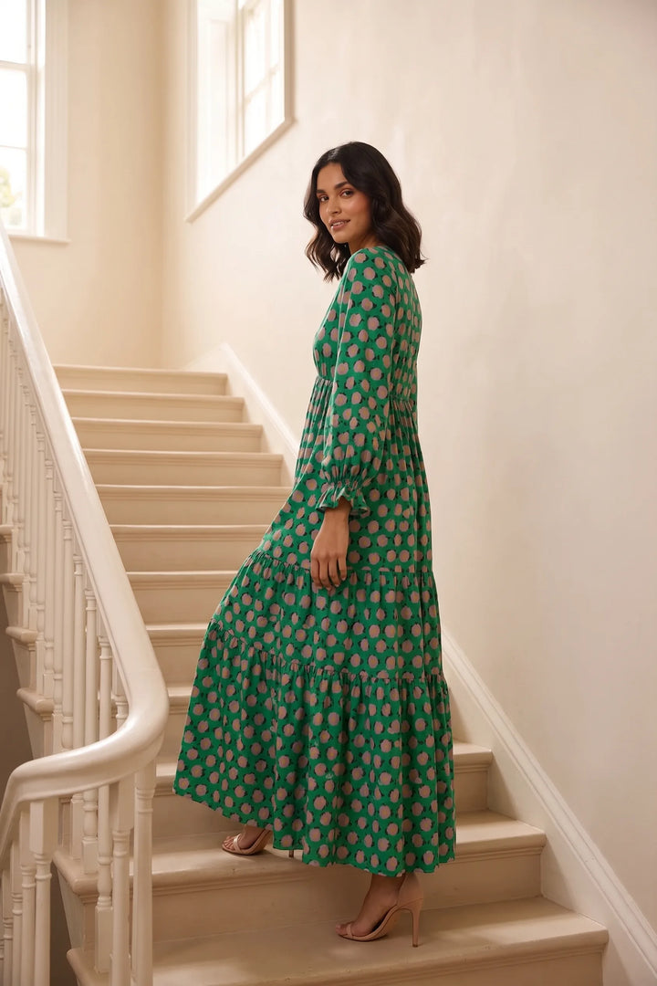 Woman in green floral tiered maxi dress in a lifestyle setting