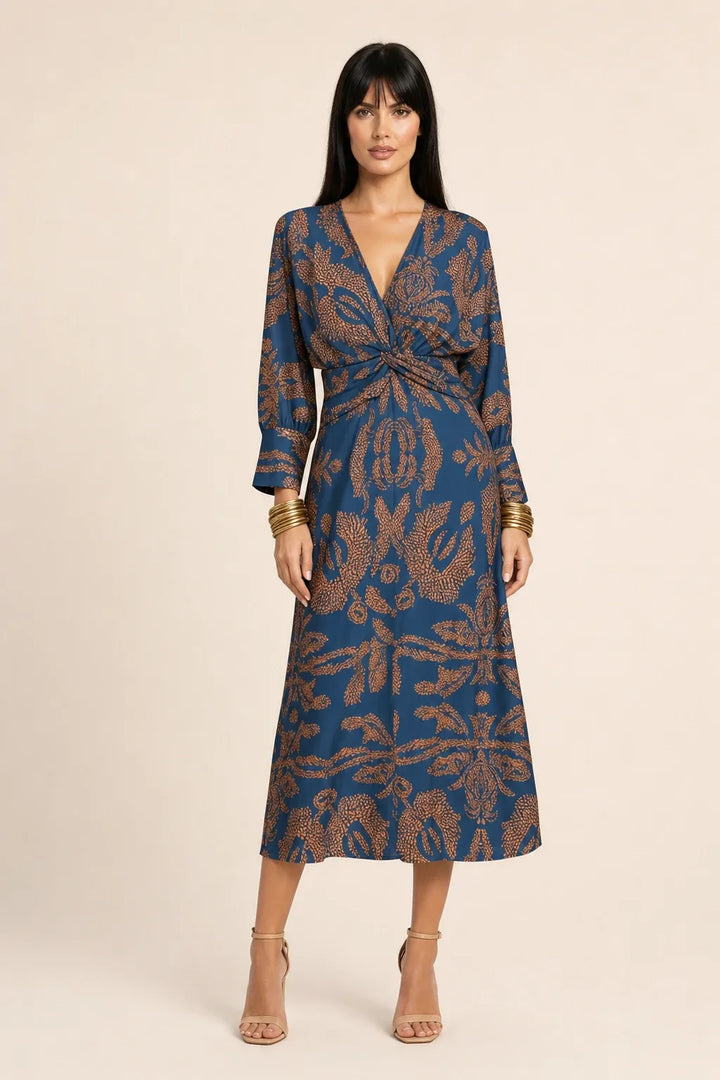 Blue twist-front midi dress on model in contrapposto stance