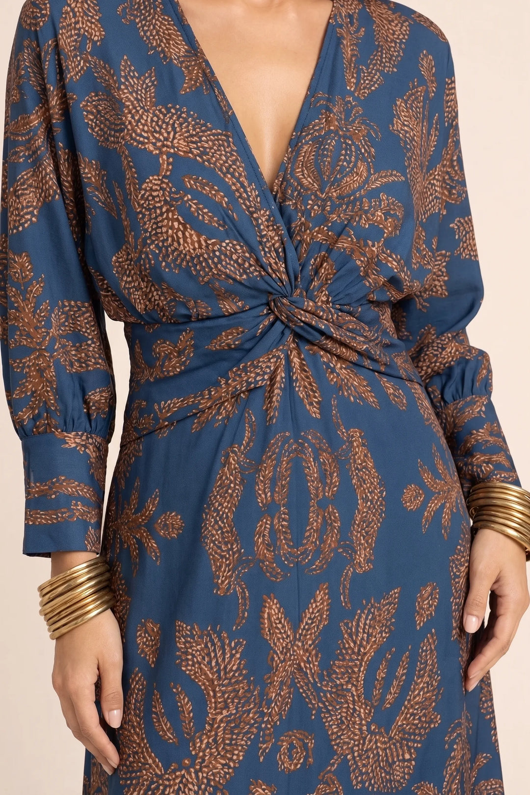 Close-up detail of twisted front bodice on blue midi dress
