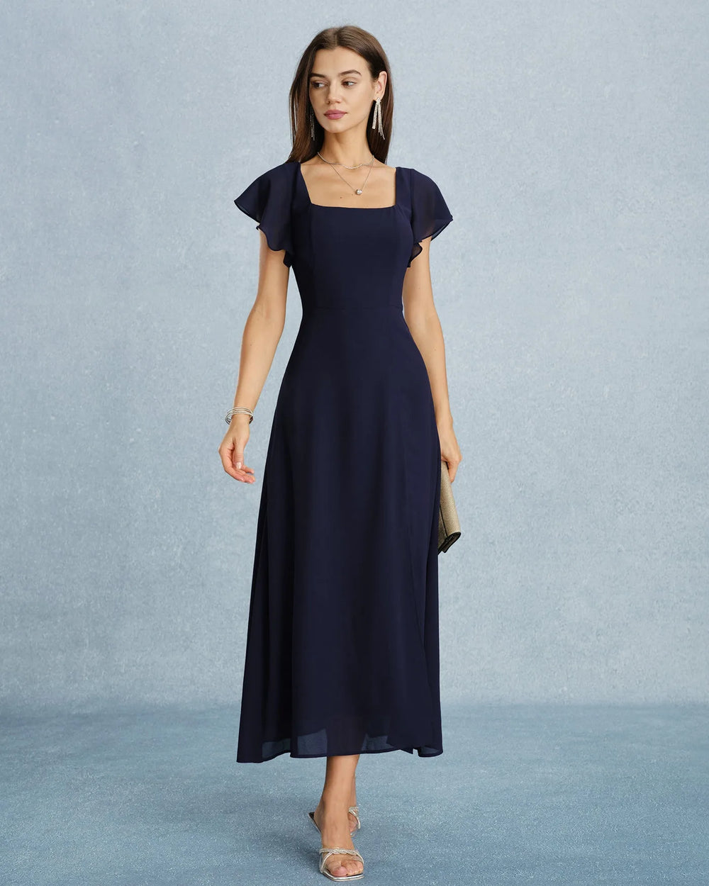 Close-up detail of flutter sleeve and fabric on navy blue maxi dress