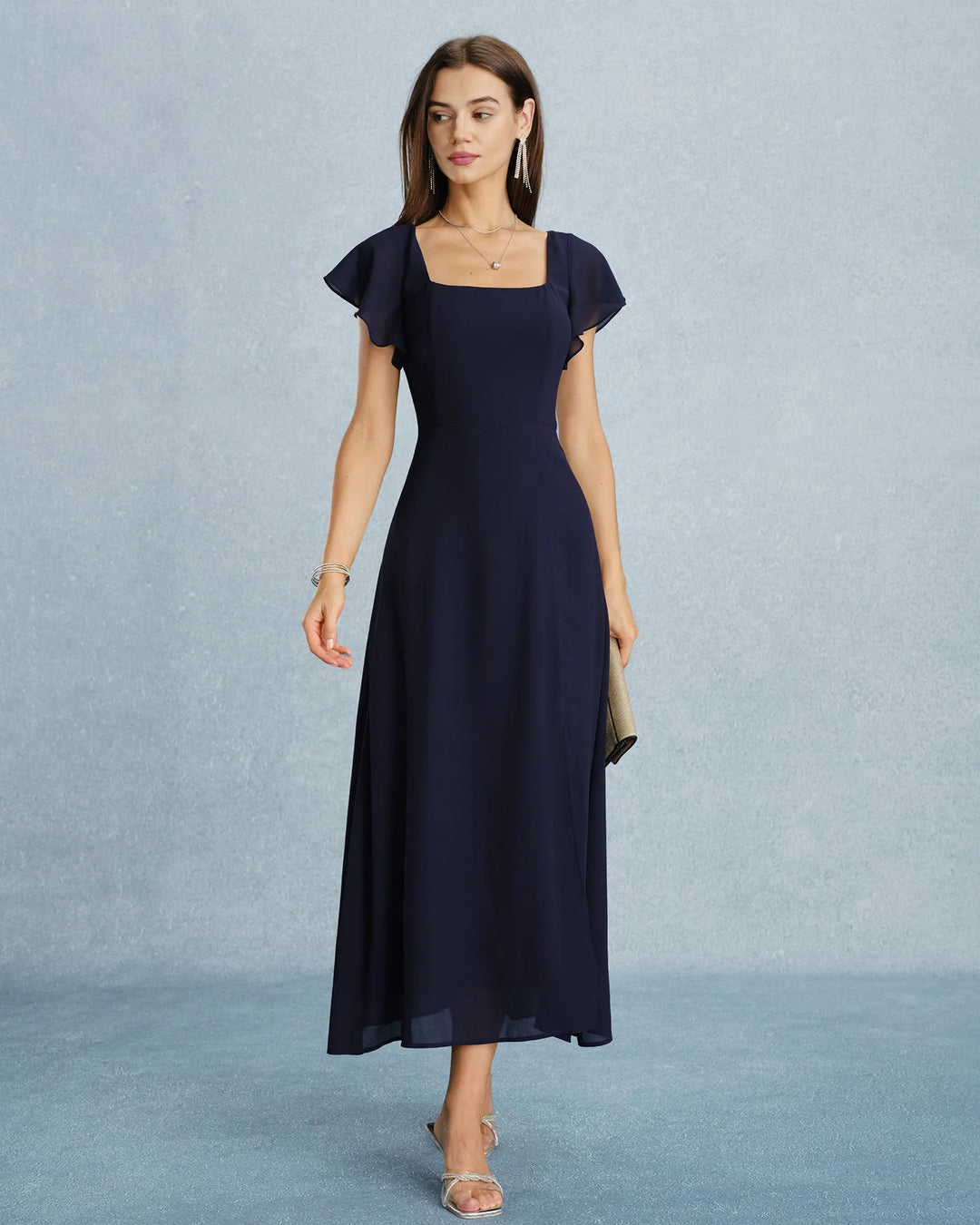 Close-up detail of flutter sleeve and fabric on navy blue maxi dress