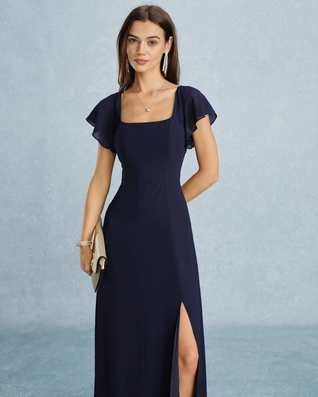 Navy blue flutter sleeve maxi dress on model from the side