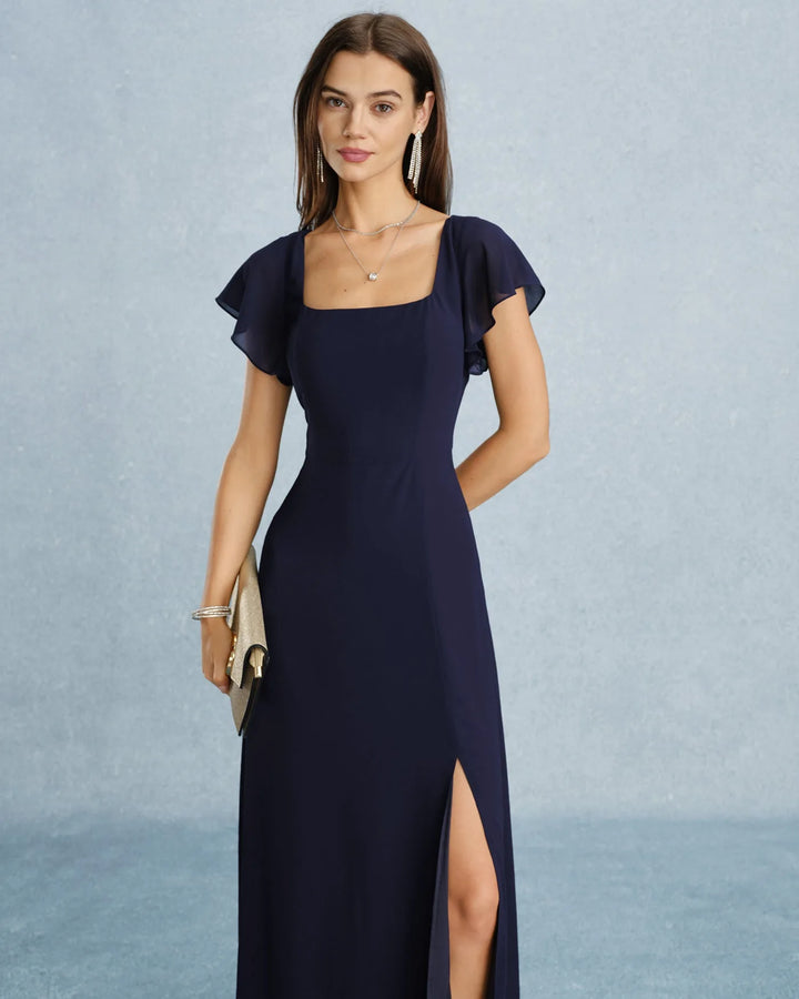 Navy blue flutter sleeve maxi dress on model from the side