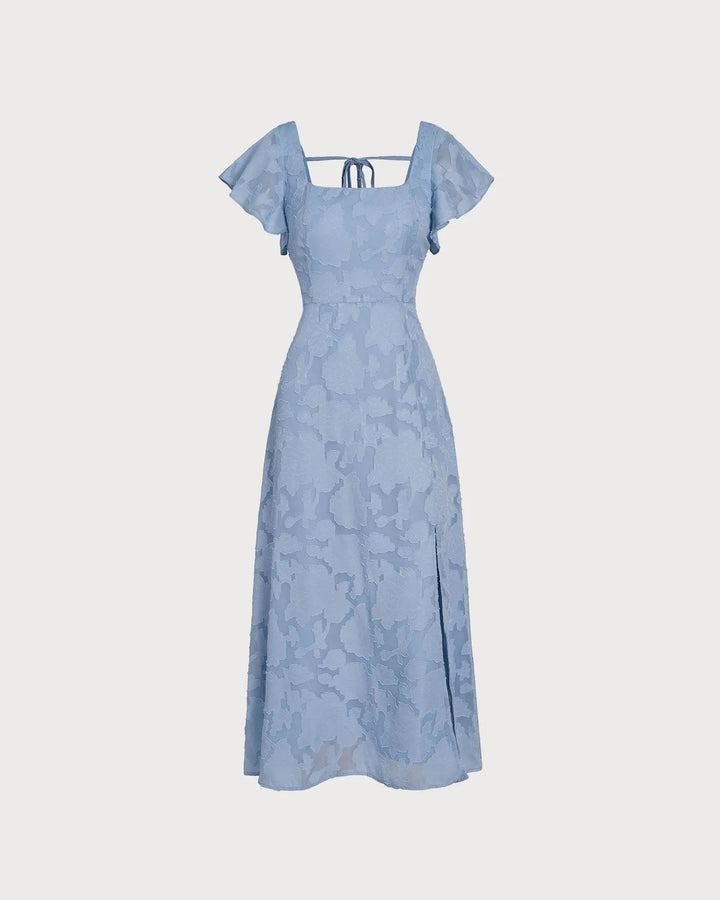 Woman in a blue flutter sleeve midi dress, viewed from the side