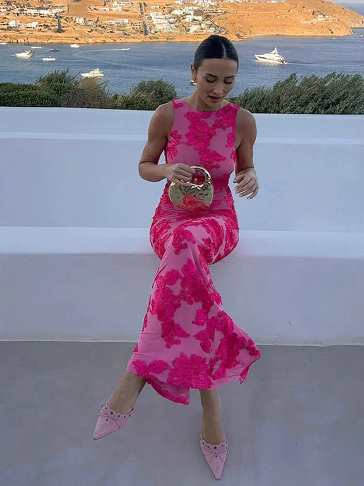 Woman posing in a beige burnout velvet floor-length gown with sheer floral overlay